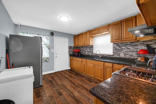 5567 W Gladys Ave, Chicago, IL 60644 - kitchen featuring exhaust hood, decorative backsplash, freestanding refrigerator, and dark wood-style floors