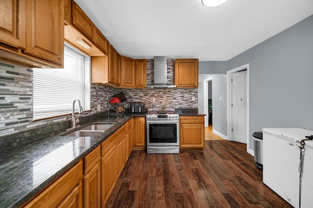 5567 W Gladys Ave, Chicago, IL 60644 - kitchen with wall chimney range hood, stainless steel range oven, fridge, dark wood-style flooring, and tasteful backsplash