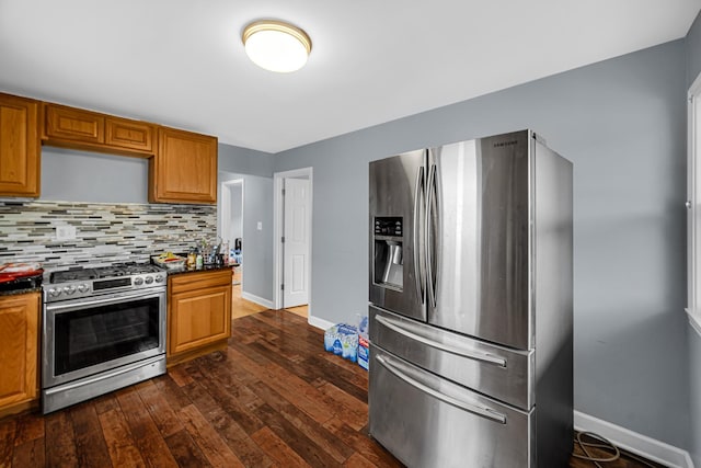 5567 W Gladys Ave, Chicago, IL 60644 - kitchen with appliances with stainless steel finishes, dark countertops, dark wood finished floors, and backsplash