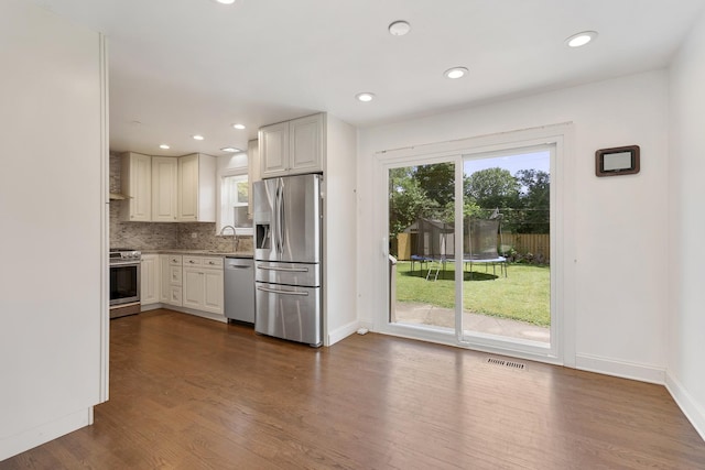 323 S Prindle Ave, Arlington Heights, IL 60004 - kitchen with stainless steel appliances, dark wood-style flooring, decorative backsplash, recessed lighting, and light countertops