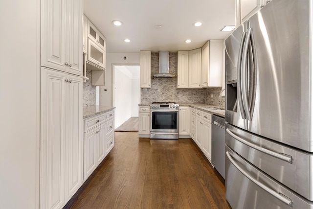 323 S Prindle Ave, Arlington Heights, IL 60004 - kitchen featuring appliances with stainless steel finishes, wall chimney exhaust hood, dark wood-type flooring, light stone counters, and backsplash