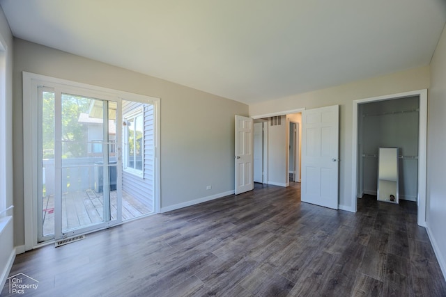 21 Elm Ct Unit 3, Bolingbrook, IL 60440 - unfurnished bedroom with dark wood-type flooring, access to exterior, a spacious closet, and a closet