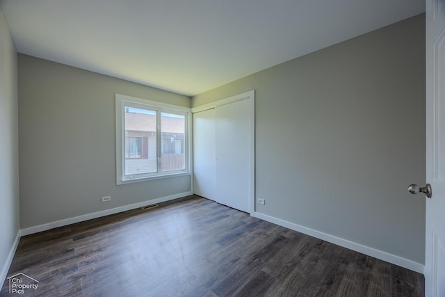 21 Elm Ct Unit 3, Bolingbrook, IL 60440 - unfurnished bedroom with dark wood-style flooring and a closet