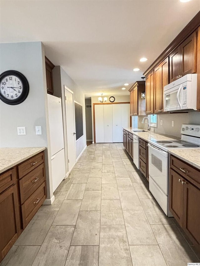 802 W Main St, La Harpe, IL 61450 - kitchen featuring white appliances, recessed lighting, and light stone countertops