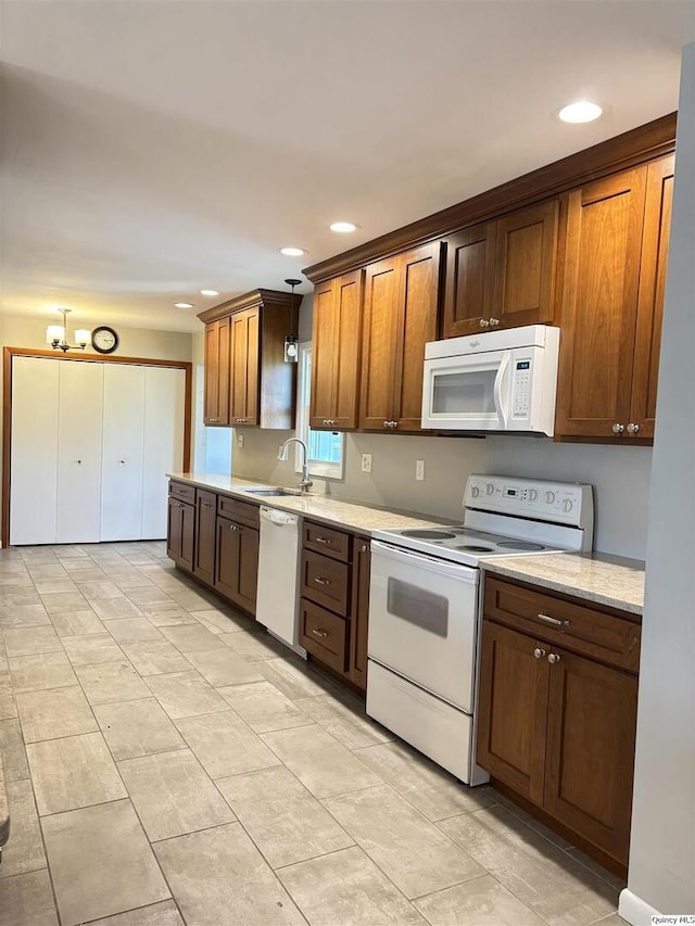 802 W Main St, La Harpe, IL 61450 - kitchen with white appliances, light countertops, and recessed lighting