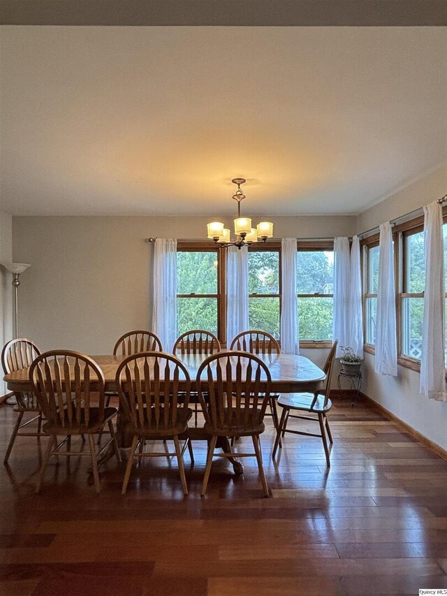 802 W Main St, La Harpe, IL 61450 - dining room with healthy amount of natural light, a chandelier, and wood-type flooring