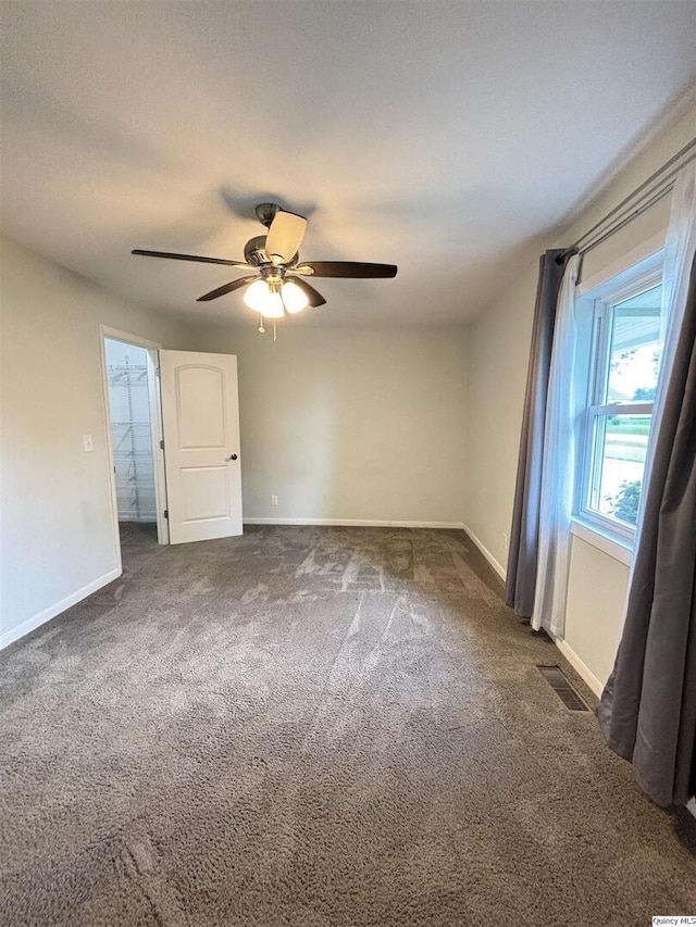 802 W Main St, La Harpe, IL 61450 - spare room featuring carpet and a ceiling fan