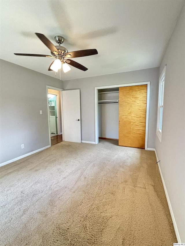 802 W Main St, La Harpe, IL 61450 - unfurnished bedroom featuring carpet, a closet, and ceiling fan