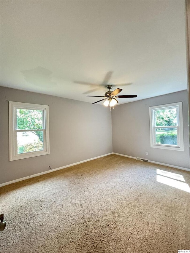 802 W Main St, La Harpe, IL 61450 - unfurnished room with carpet floors and a ceiling fan