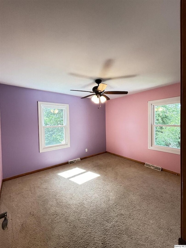 802 W Main St, La Harpe, IL 61450 - carpeted spare room featuring ceiling fan and baseboards
