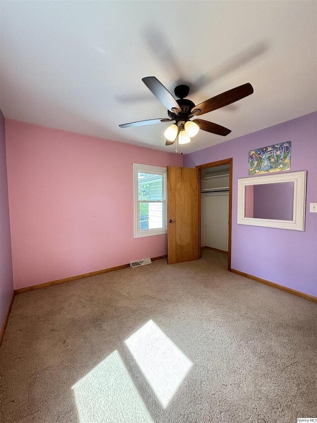 802 W Main St, La Harpe, IL 61450 - unfurnished bedroom featuring light colored carpet, a closet, and ceiling fan