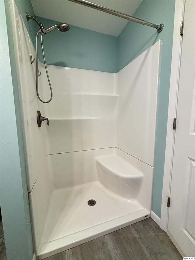 802 W Main St, La Harpe, IL 61450 - full bathroom with a shower and wood finished floors