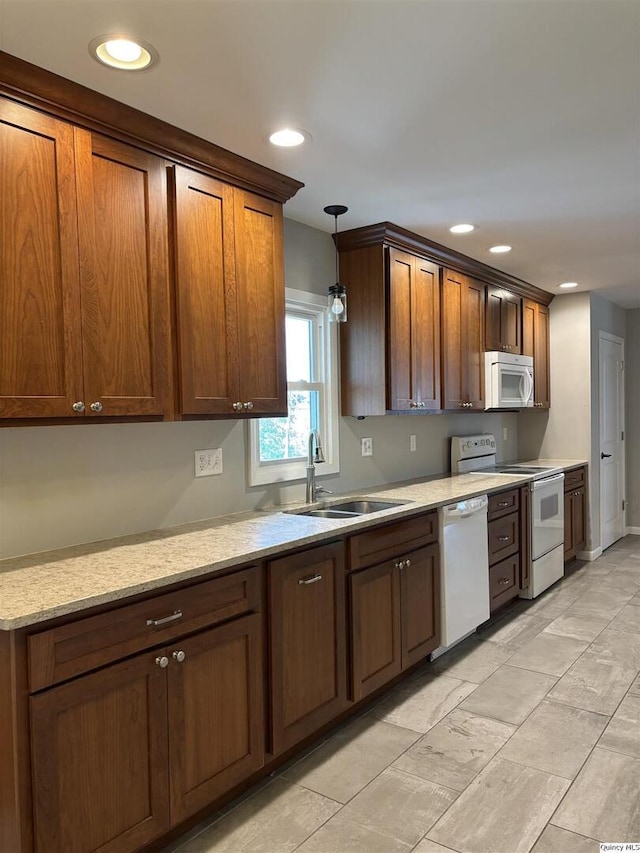 802 W Main St, La Harpe, IL 61450 - kitchen with white appliances, recessed lighting, decorative light fixtures, light stone counters, and brown cabinetry