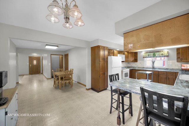 506 S 5th St, Malta, IL 60150 - dining area with a chandelier and light flooring