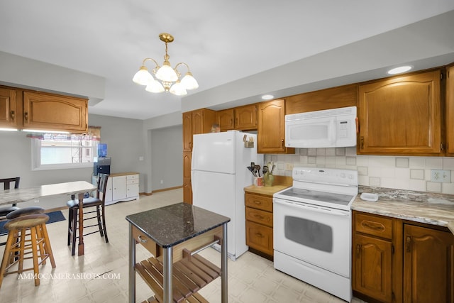 506 S 5th St, Malta, IL 60150 - kitchen featuring white appliances, light flooring, a chandelier, and brown cabinets