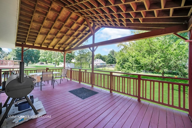 506 S 5th St, Malta, IL 60150 - wooden deck with outdoor dining area and view of wooded area