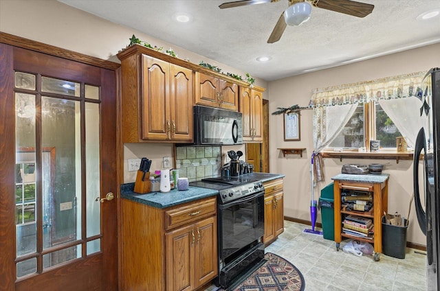 519 S 4th St, Fairbury, IL 61739 - kitchen with black appliances, brown cabinets, a ceiling fan, dark countertops, and backsplash