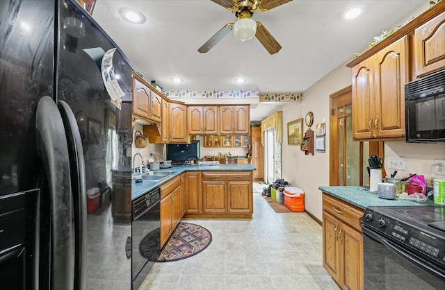 519 S 4th St, Fairbury, IL 61739 - kitchen with black appliances, ceiling fan, recessed lighting, brown cabinetry, and a peninsula