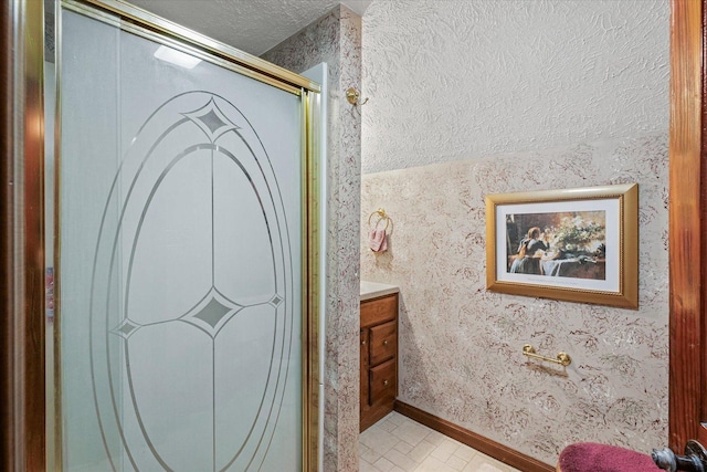 519 S 4th St, Fairbury, IL 61739 - full bath with vanity, a textured ceiling, and a shower with shower door