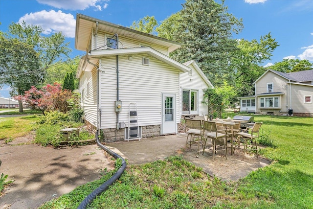 519 S 4th St, Fairbury, IL 61739 - back of property featuring a lawn and a patio
