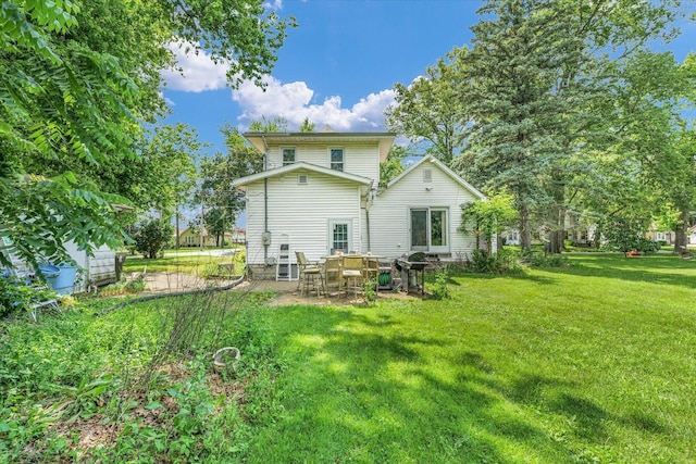 519 S 4th St, Fairbury, IL 61739 - back of property featuring a yard and a patio area