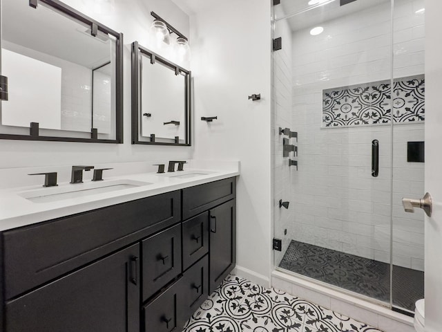 1801 W Diversey Pkwy Unit 36, Chicago, IL 60614 - bathroom with double vanity, a shower stall, and tile patterned floors