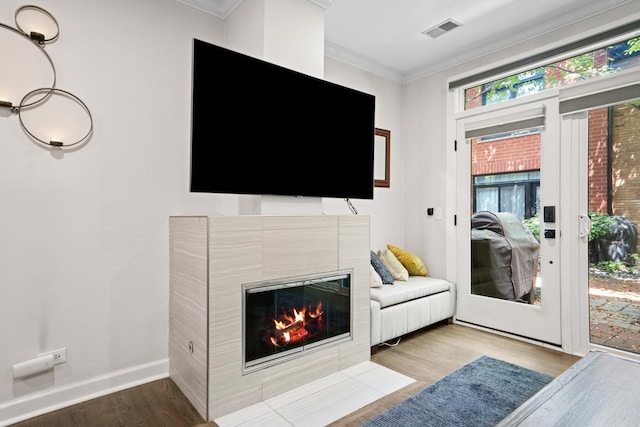 1801 W Diversey Pkwy Unit 36, Chicago, IL 60614 - living area with wood finished floors, crown molding, and a tile fireplace