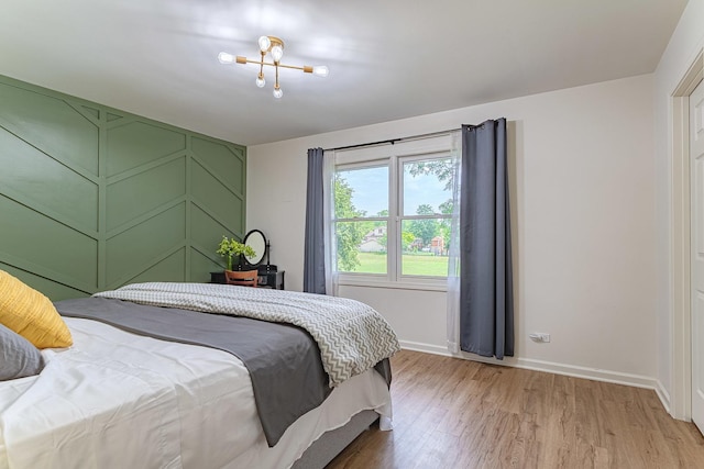 7559 Kingsbury Dr, Hanover Park, IL 60133 - bedroom with light wood-style floors and a chandelier