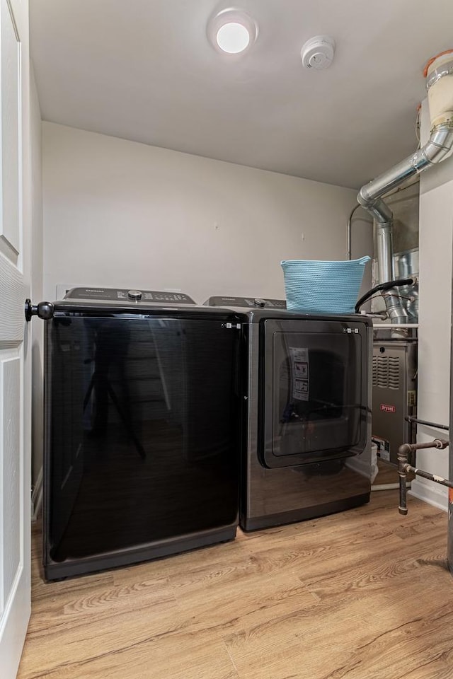 7559 Kingsbury Dr, Hanover Park, IL 60133 - washroom featuring washer and dryer and light wood-type flooring