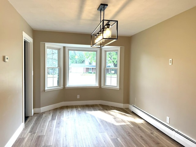 3814 Abbotsford Rd, Rockford, IL 61107 - unfurnished dining area featuring a baseboard heating unit and light wood-style floors