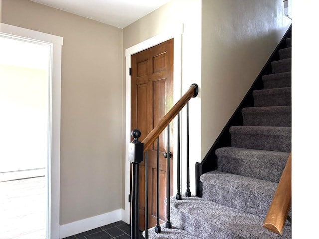 3814 Abbotsford Rd, Rockford, IL 61107 - staircase featuring tile patterned floors and baseboards