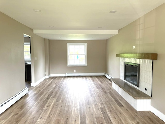 3814 Abbotsford Rd, Rockford, IL 61107 - unfurnished living room featuring a baseboard radiator, a baseboard heating unit, plenty of natural light, and a glass covered fireplace