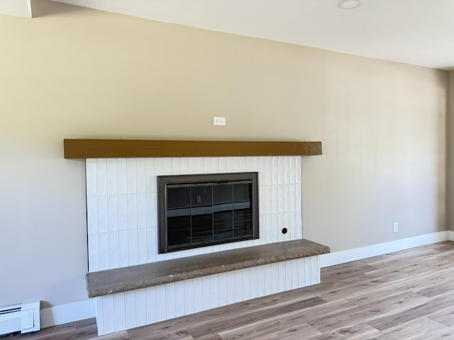 3814 Abbotsford Rd, Rockford, IL 61107 - detailed view of a glass covered fireplace, wood finished floors, baseboard heating, and recessed lighting
