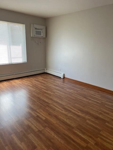 291 Gregory St Unit 6, Aurora, IL 60504 - empty room with dark wood-style flooring and a wall mounted AC