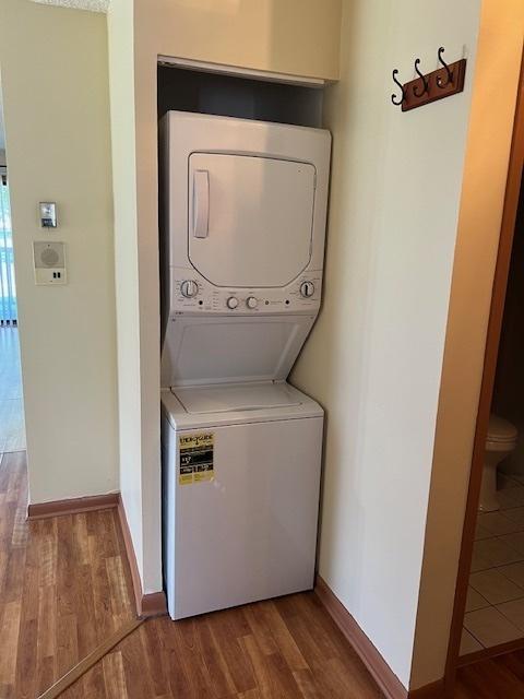 291 Gregory St Unit 6, Aurora, IL 60504 - laundry area featuring stacked washing machine and dryer and wood finished floors