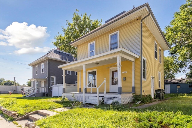 1304 E 4th St, Sterling, IL 61081 - traditional style home featuring a porch and a front lawn