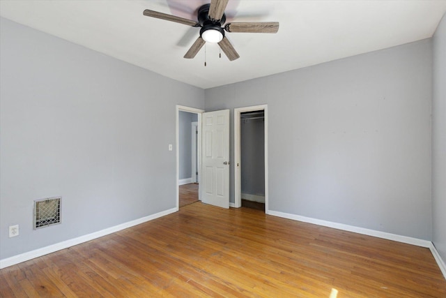 1304 E 4th St, Sterling, IL 61081 - unfurnished bedroom with light wood-type flooring, a closet, and a ceiling fan