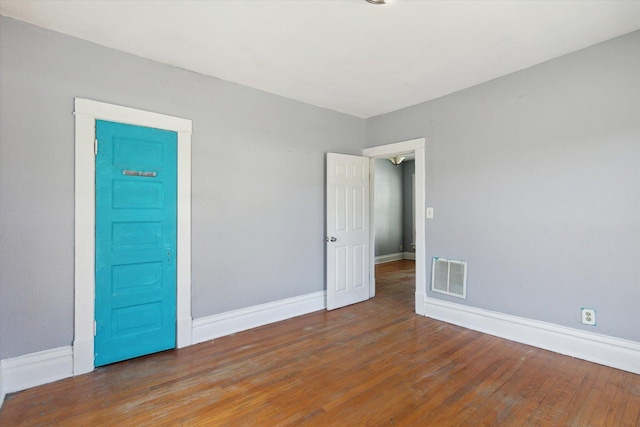 1304 E 4th St, Sterling, IL 61081 - spare room featuring wood finished floors and baseboards