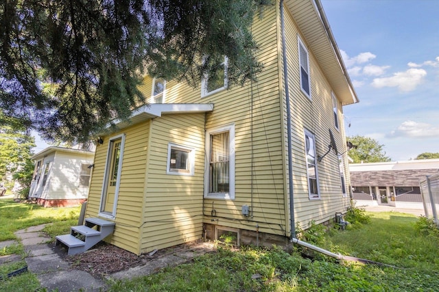 1304 E 4th St, Sterling, IL 61081 - view of property exterior with entry steps and a lawn
