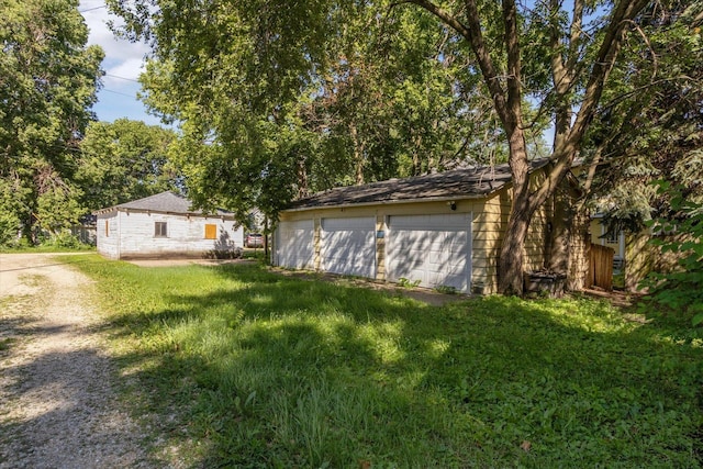 1304 E 4th St, Sterling, IL 61081 - view of grassy yard with an outdoor structure and a garage