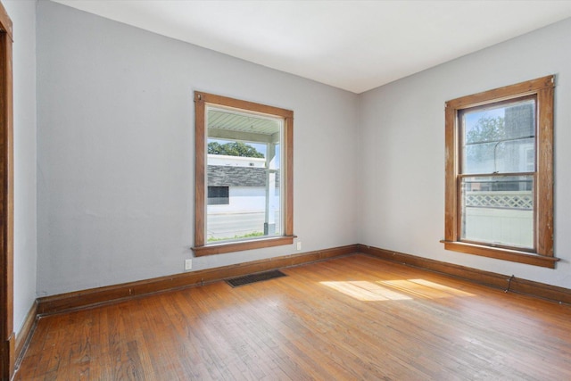 1304 E 4th St, Sterling, IL 61081 - empty room featuring hardwood / wood-style floors and baseboards