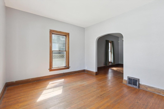 1304 E 4th St, Sterling, IL 61081 - spare room with arched walkways and wood finished floors