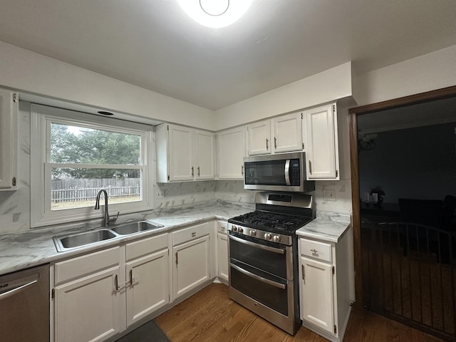 1970 Division St, Saint Charles, IL 60174 - kitchen with appliances with stainless steel finishes, white cabinets, and wood finished floors