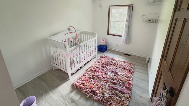1970 Division St, Saint Charles, IL 60174 - bedroom featuring wood finished floors and a nursery area