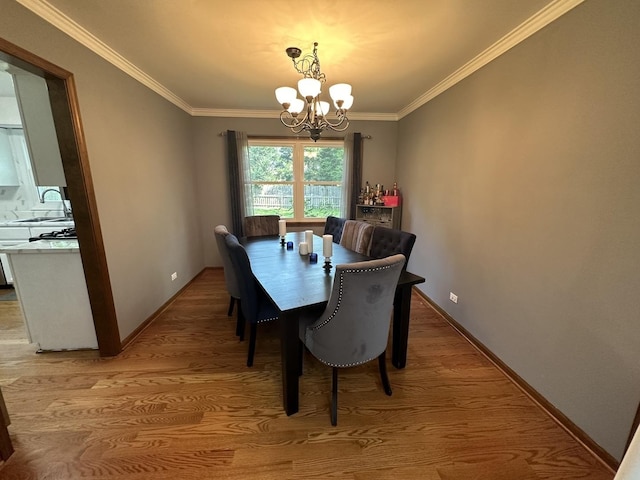 1970 Division St, Saint Charles, IL 60174 - dining space featuring a chandelier, light wood-style flooring, and crown molding