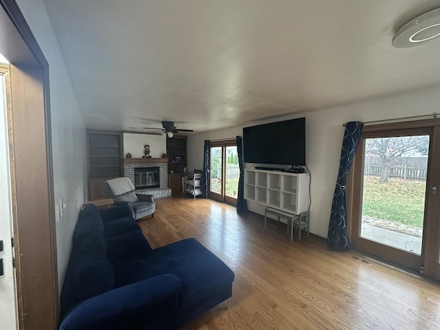 1970 Division St, Saint Charles, IL 60174 - living room featuring wood finished floors, a fireplace, and a ceiling fan
