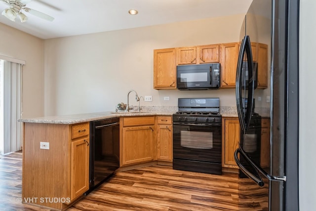 2501 Park Ridge Ct Unit 2501, Crest Hill, IL 60403 - kitchen featuring black appliances, a peninsula, light wood-type flooring, a ceiling fan, and light stone counters