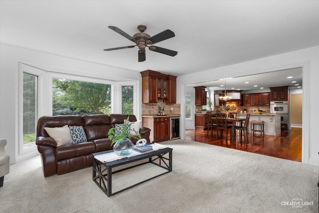 1112 Saratoga Ct, Naperville, IL 60564 - living room with light carpet, beverage cooler, a ceiling fan, recessed lighting, and a chandelier