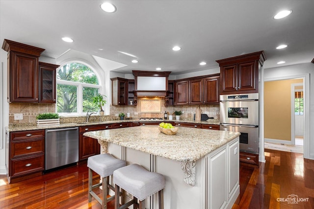 1112 Saratoga Ct, Naperville, IL 60564 - kitchen featuring stainless steel appliances, plenty of natural light, dark wood-style flooring, a center island, and recessed lighting