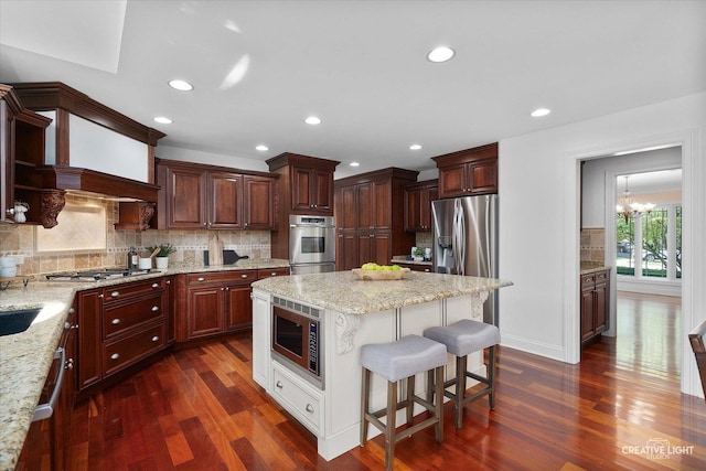 1112 Saratoga Ct, Naperville, IL 60564 - kitchen featuring appliances with stainless steel finishes, dark wood-style flooring, a kitchen breakfast bar, backsplash, and recessed lighting